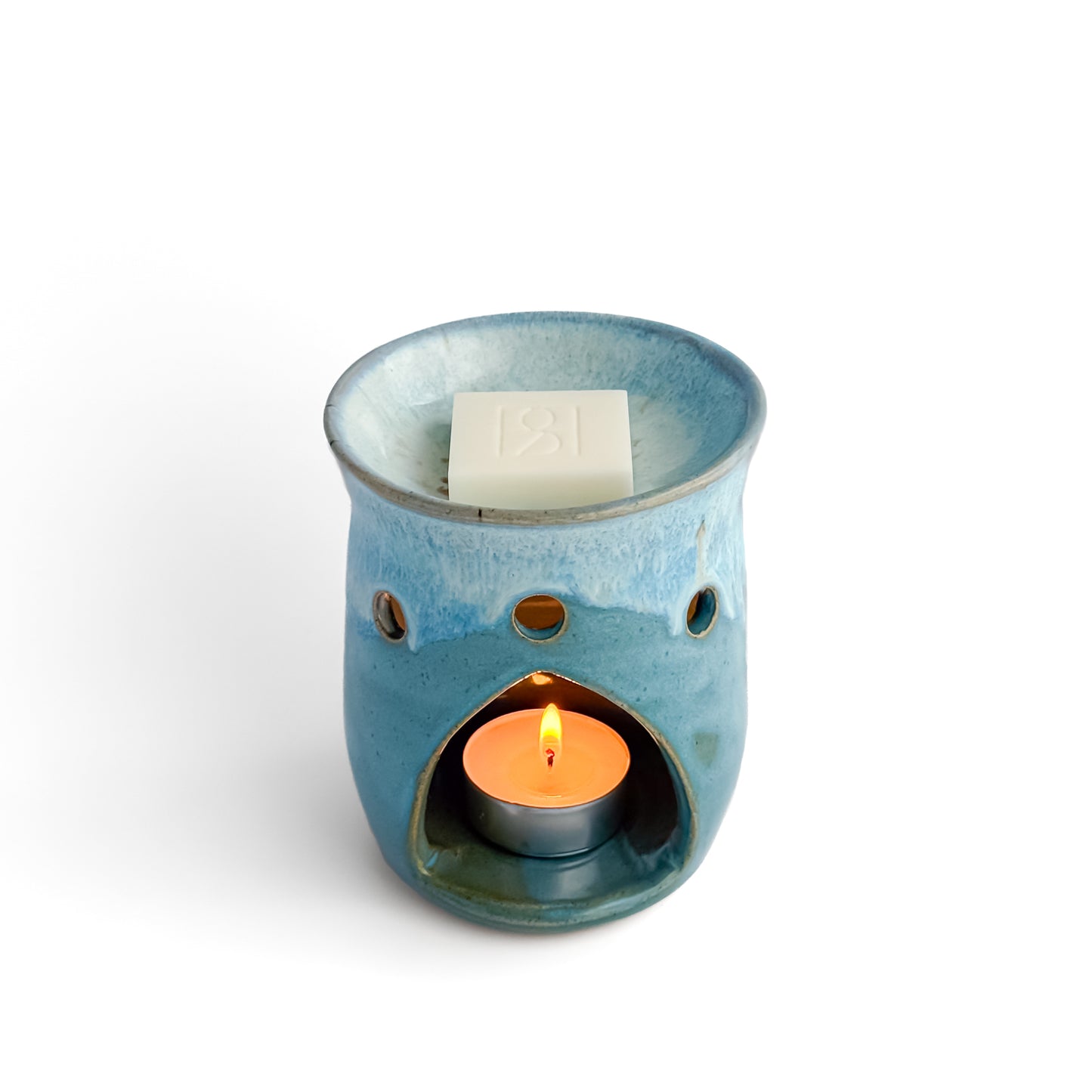 Leonore ceramic wax melt warmer in Azure Blue, with glowing tea light