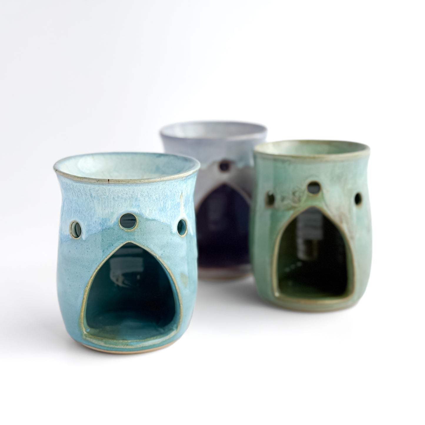 A trio of Leonore wax melt warmers with Azure Blue shown at the front