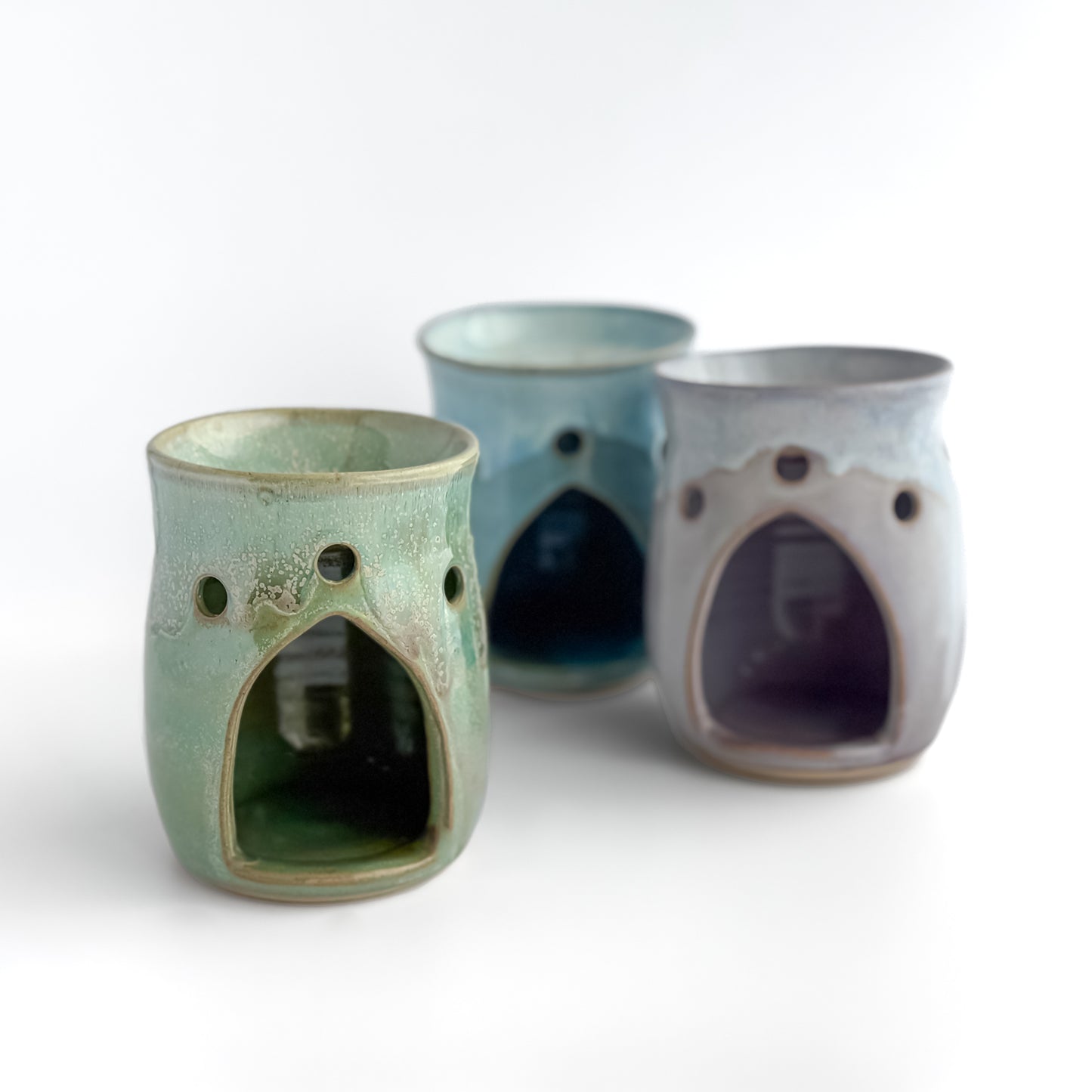 A trio of Leonore wax melt warmers with Hazel Green shown at the front