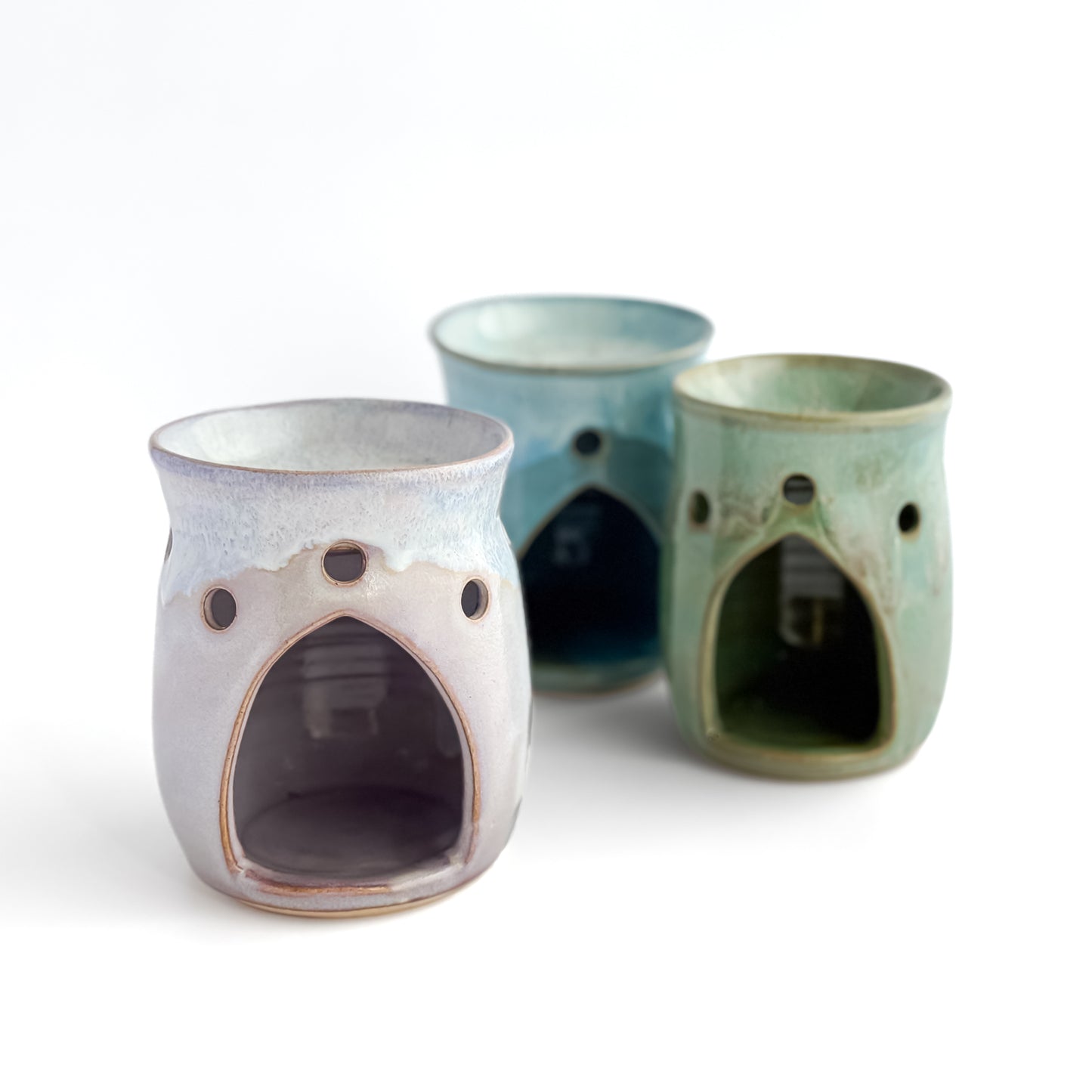 A trio of Leonore wax melt warmers with Lavender Haze shown at the front