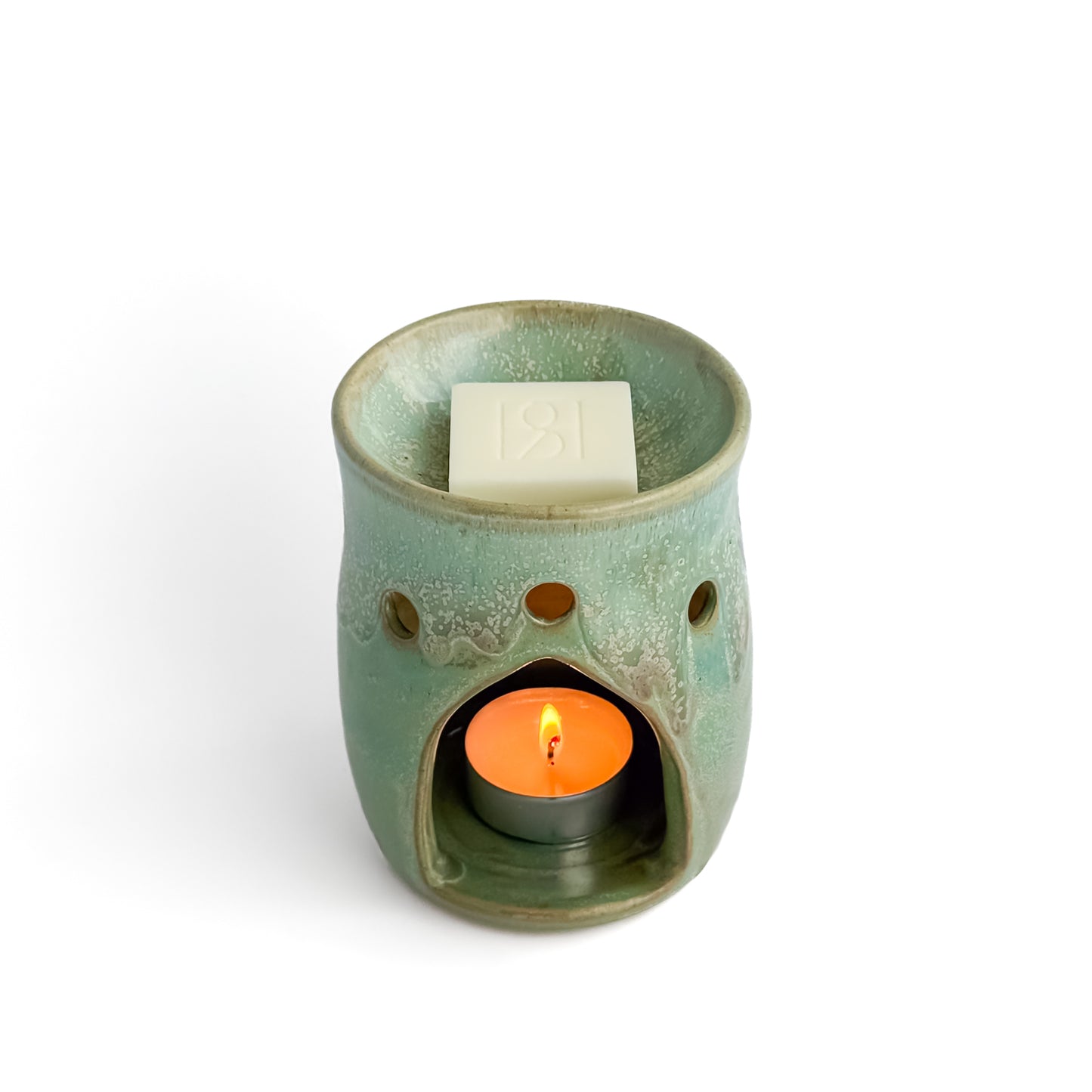 Leonore ceramic wax melt warmer in Hazel Green, with a Rosie & B wax melt and a glowing tealight