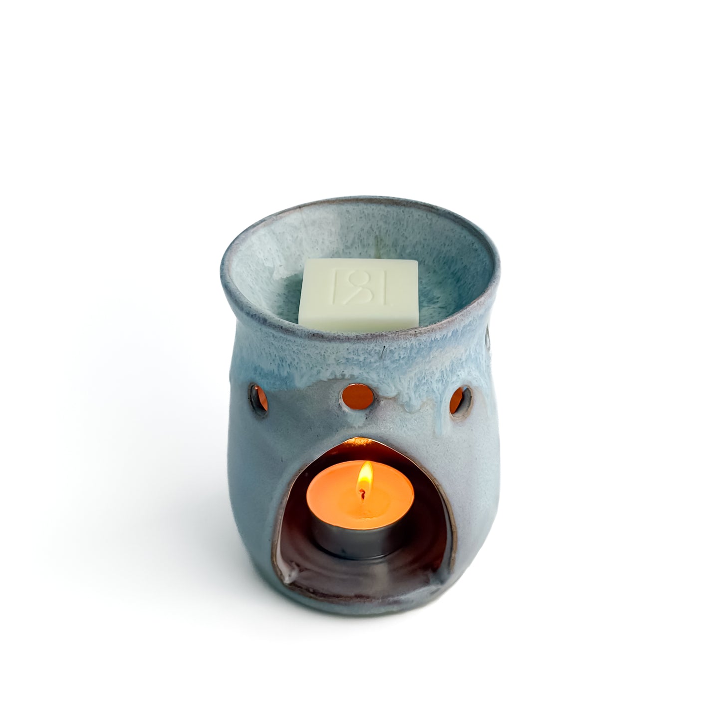 Leonore ceramic wax melt warmer in Lavender Haze, with a Rosie & B wax melt and a glowing tealight