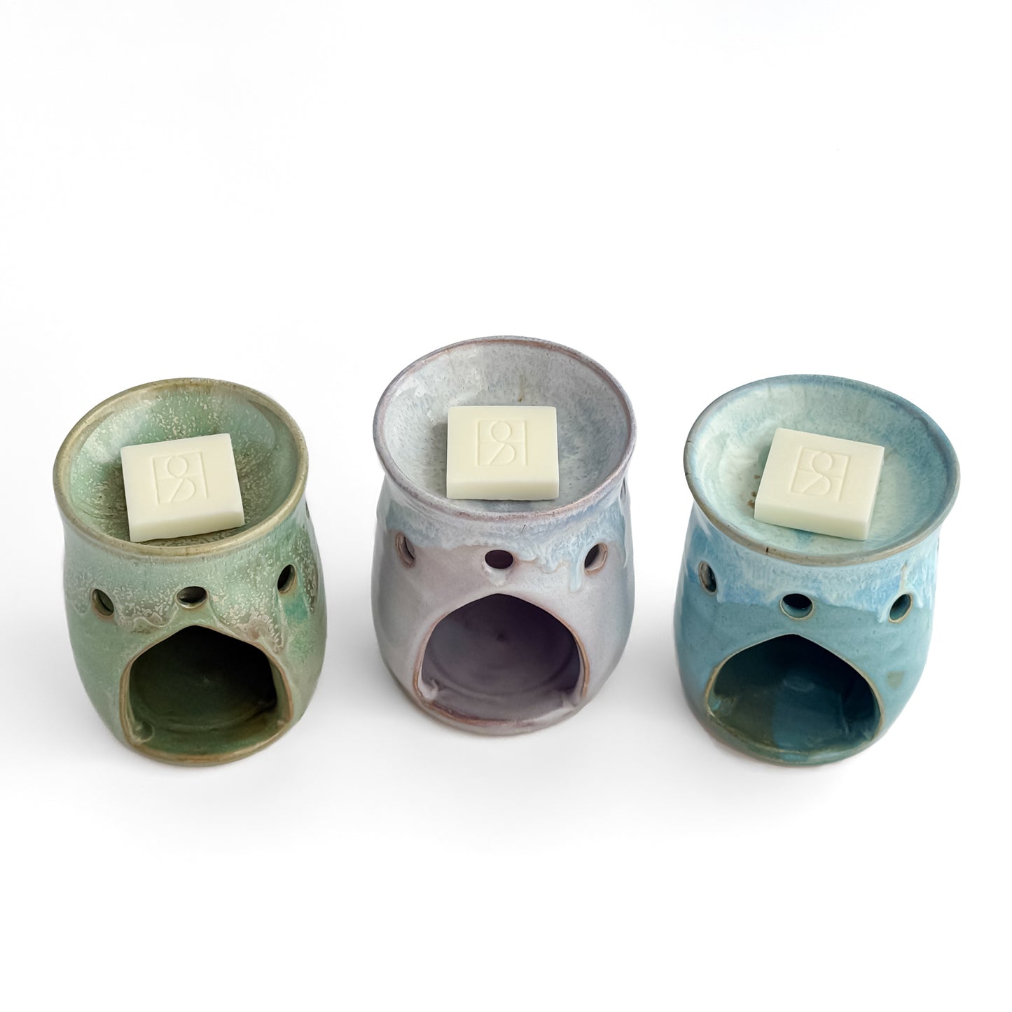 A trio of Leonore wax melt warmers in Hazel Green, Lavender Haze and Azure Blue, with Rosie & B wax melts