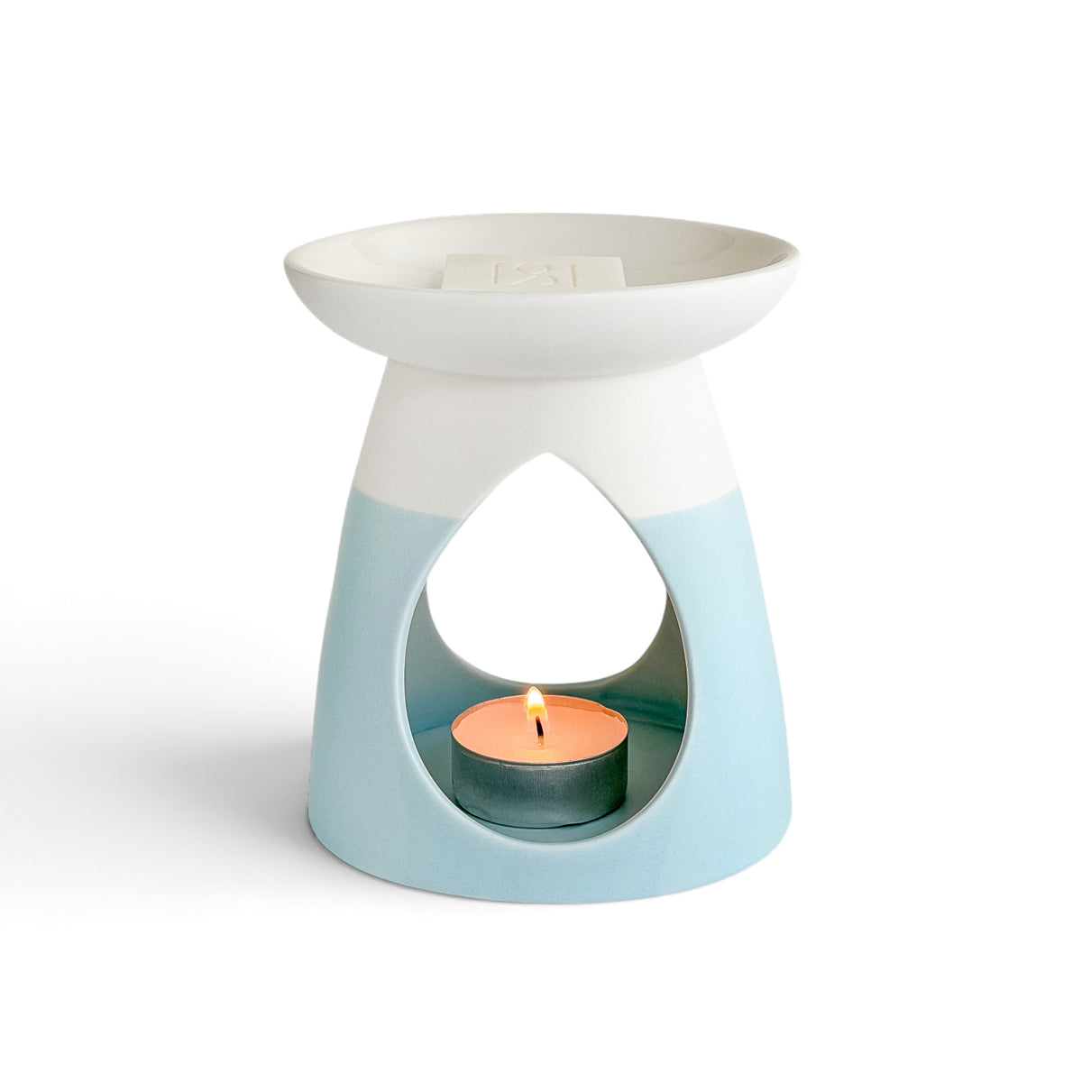 Arabella ceramic wax warmer in powder blue with a glowing tea light