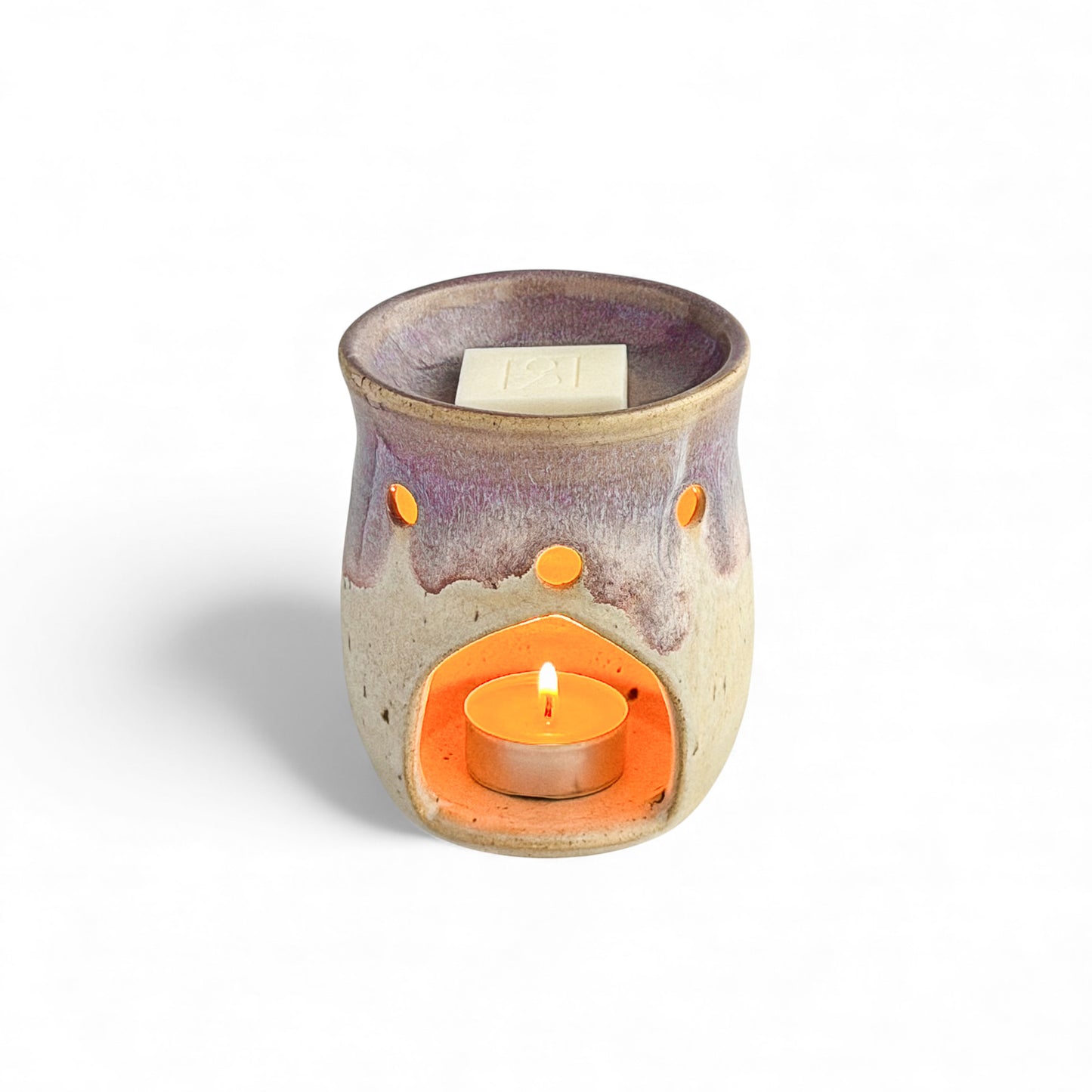 Leonore ceramic wax melt warmer in Lavender Haze & Oatmeal, shown with a Rosie & B wax melt and a glowing tea light