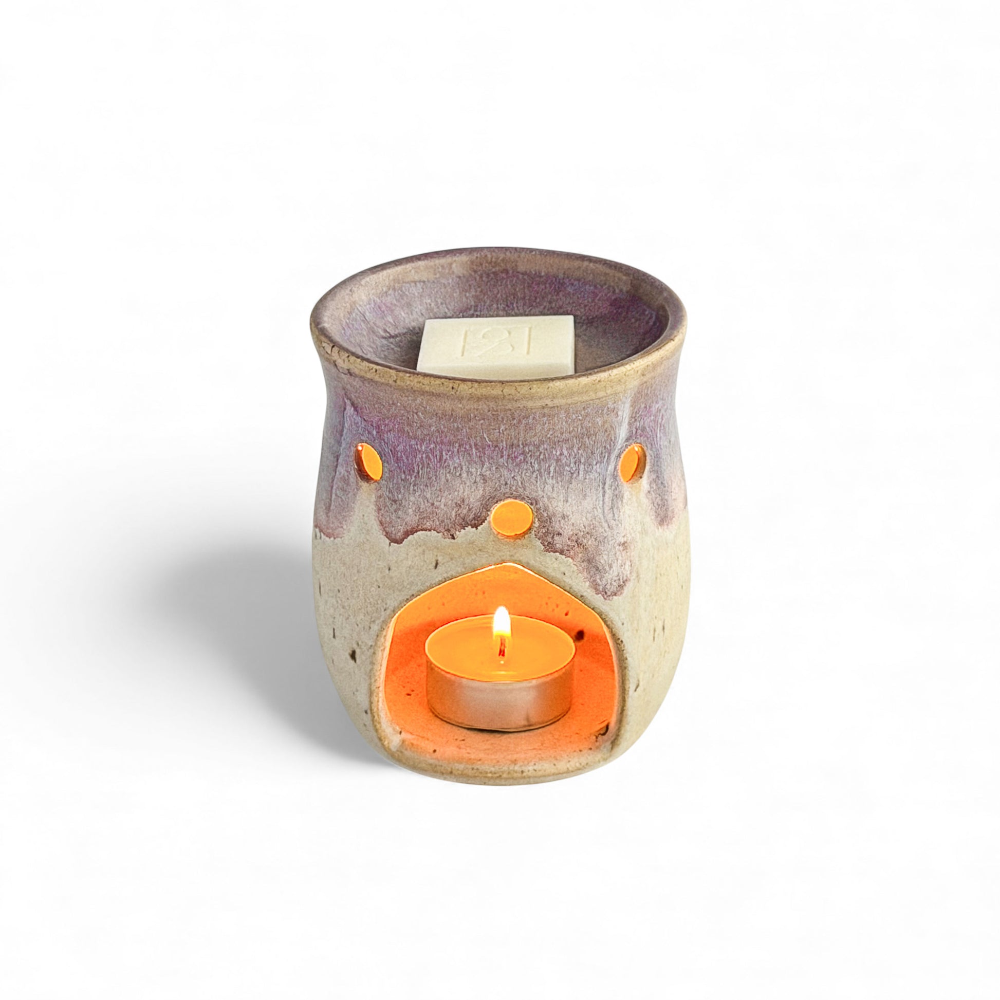 Leonore ceramic wax melt warmer in Lavender Haze & Oatmeal, shown with a Rosie & B wax melt and a glowing tea light