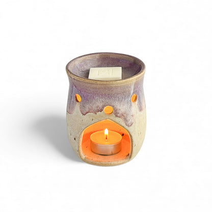 Leonore ceramic wax melt warmer in Lavender Haze & Oatmeal, shown with a Rosie & B wax melt and a glowing tea light