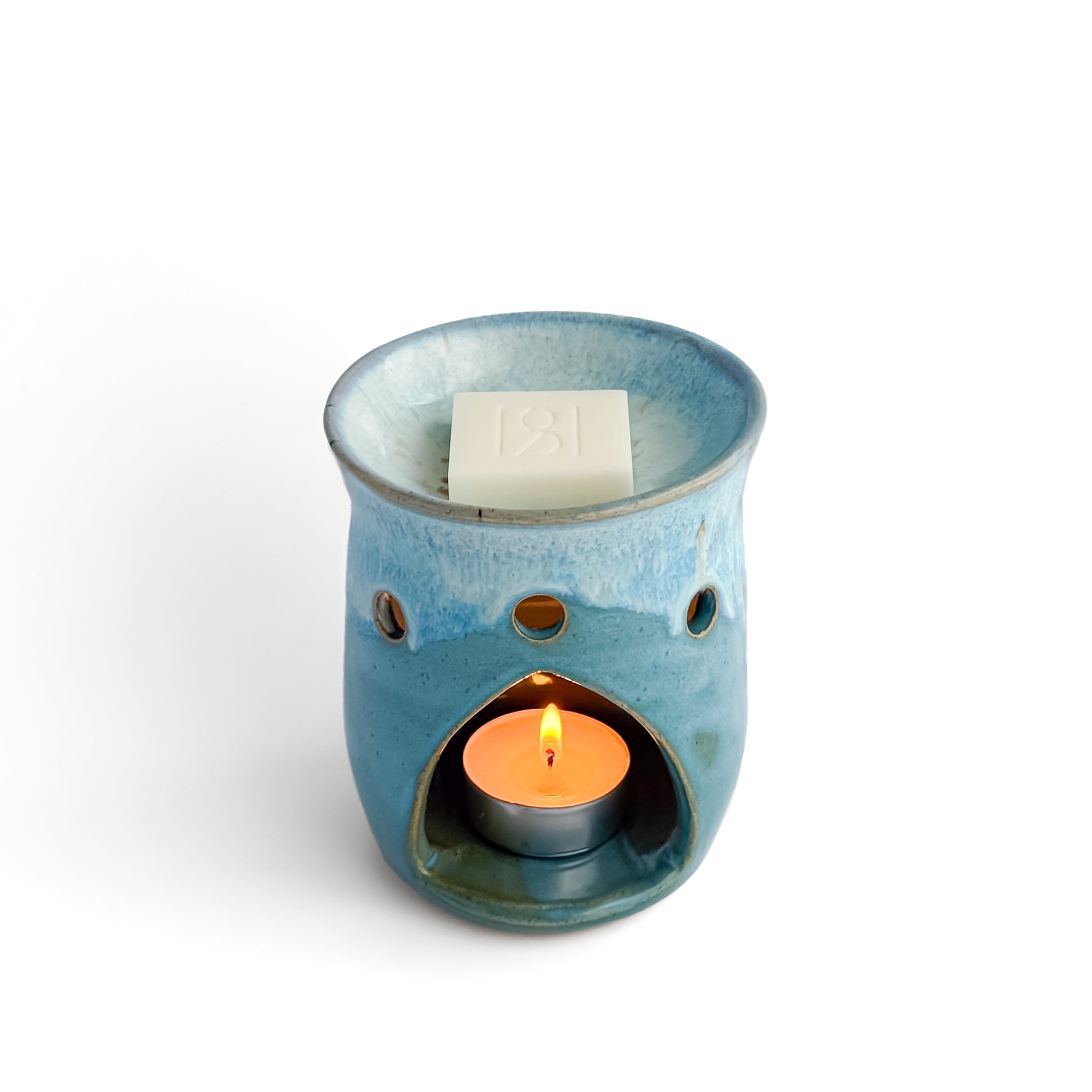 Leonore ceramic wax melt warmer in Azure Blue, with glowing tea light