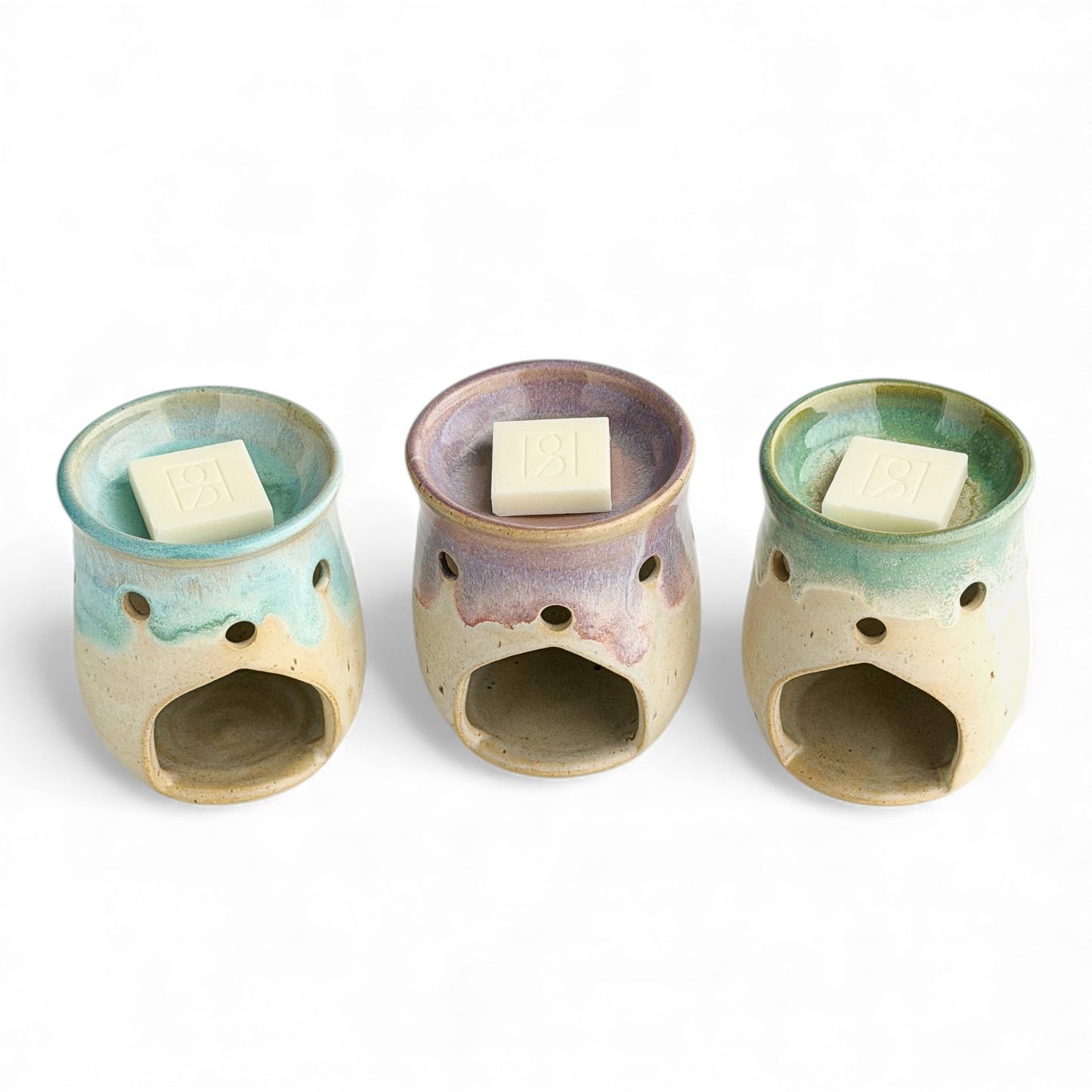 A trio of Leonore wax melt warmers in Azure Blue & Oatmeal, Lavender Haze & Oatmeal and Hazel Green & Oatmeal, shown with Rosie & B wax melts