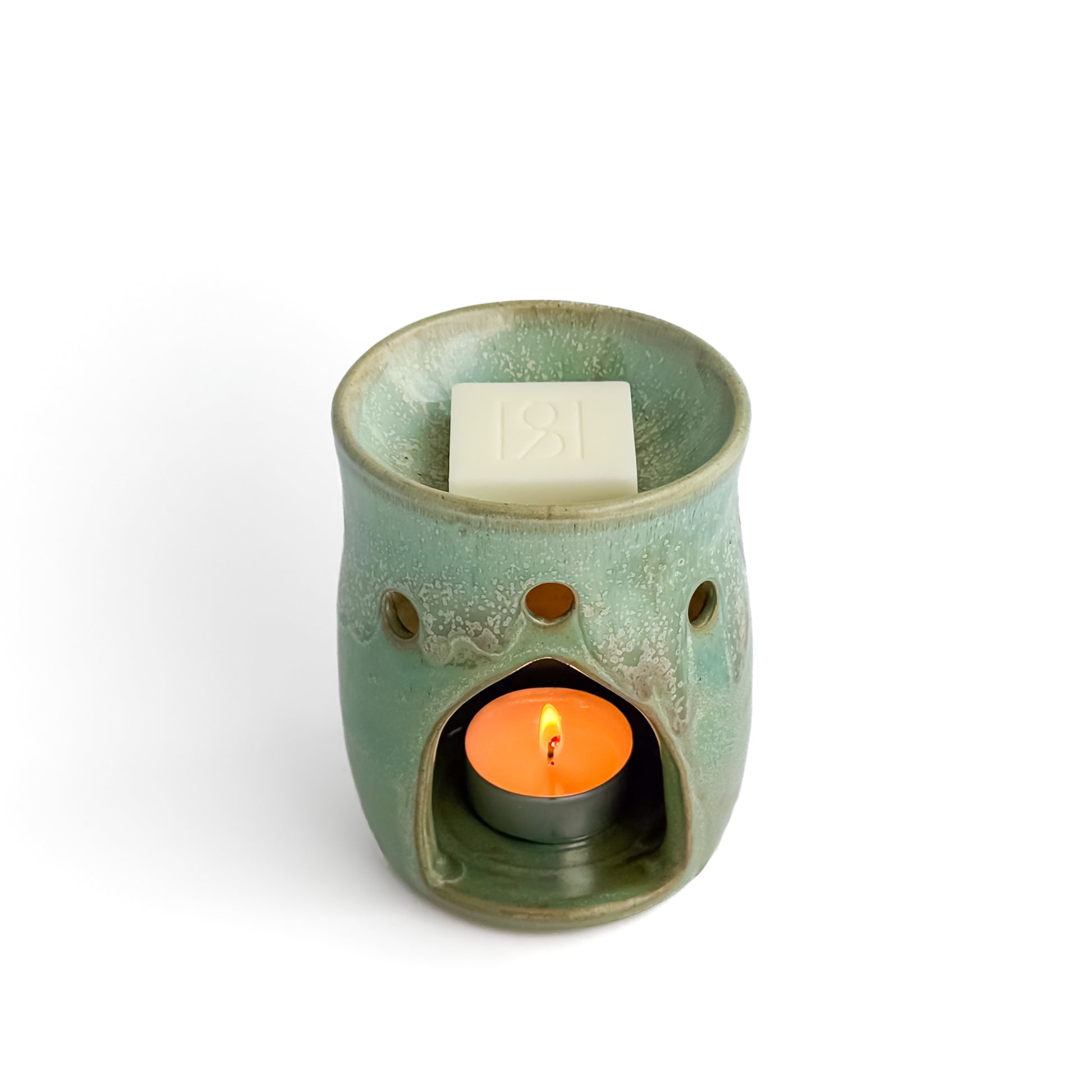 Leonore ceramic wax melt warmer in Hazel Green, with a Rosie & B wax melt and a glowing tealight