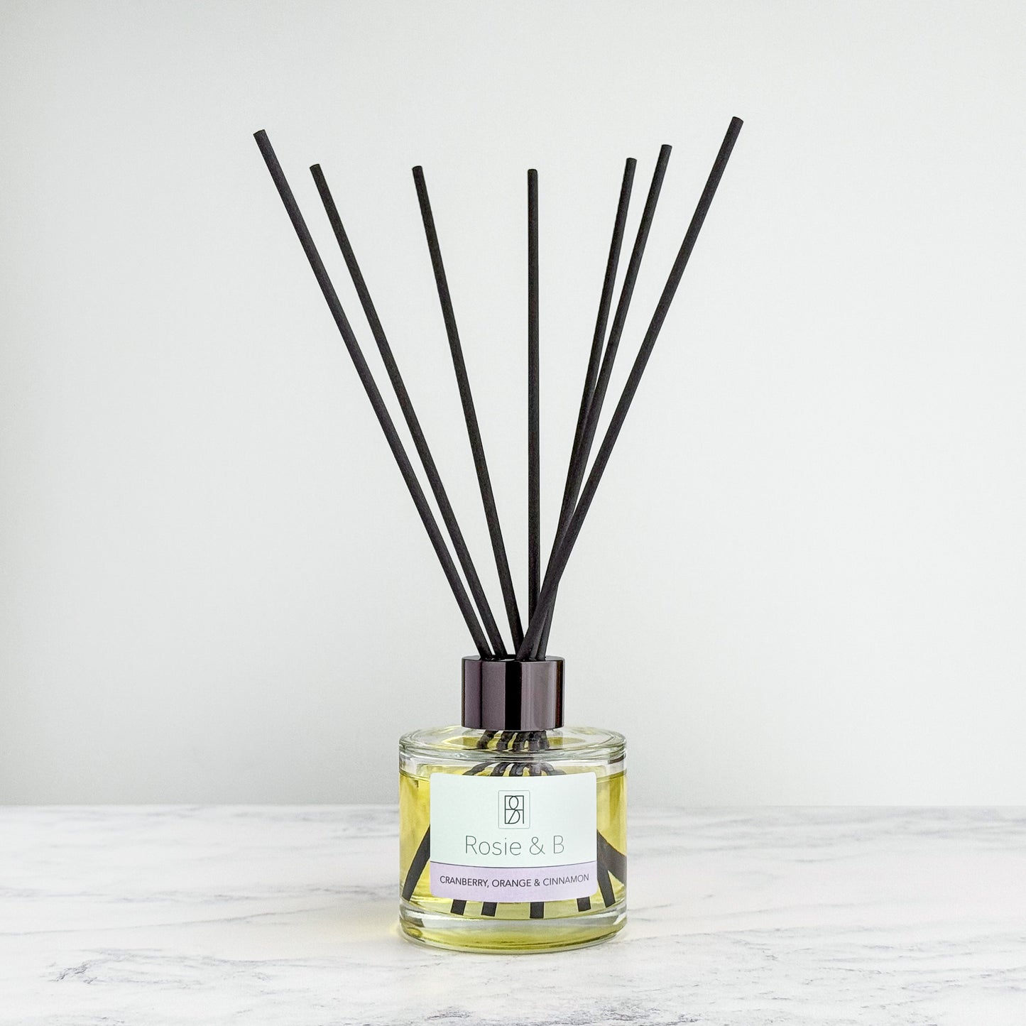 Cranberry, Orange & Cinnamon reed diffuser bottle with reeds
