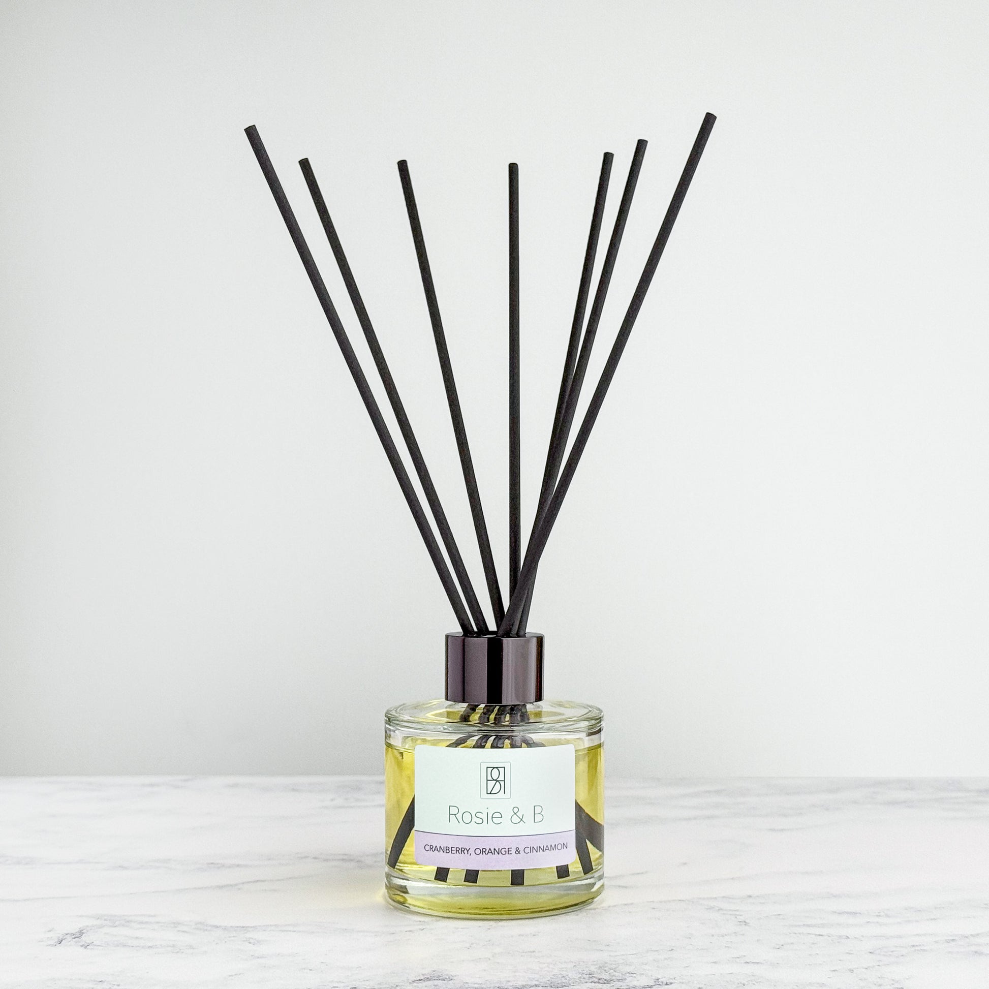 Cranberry, Orange & Cinnamon reed diffuser bottle with reeds