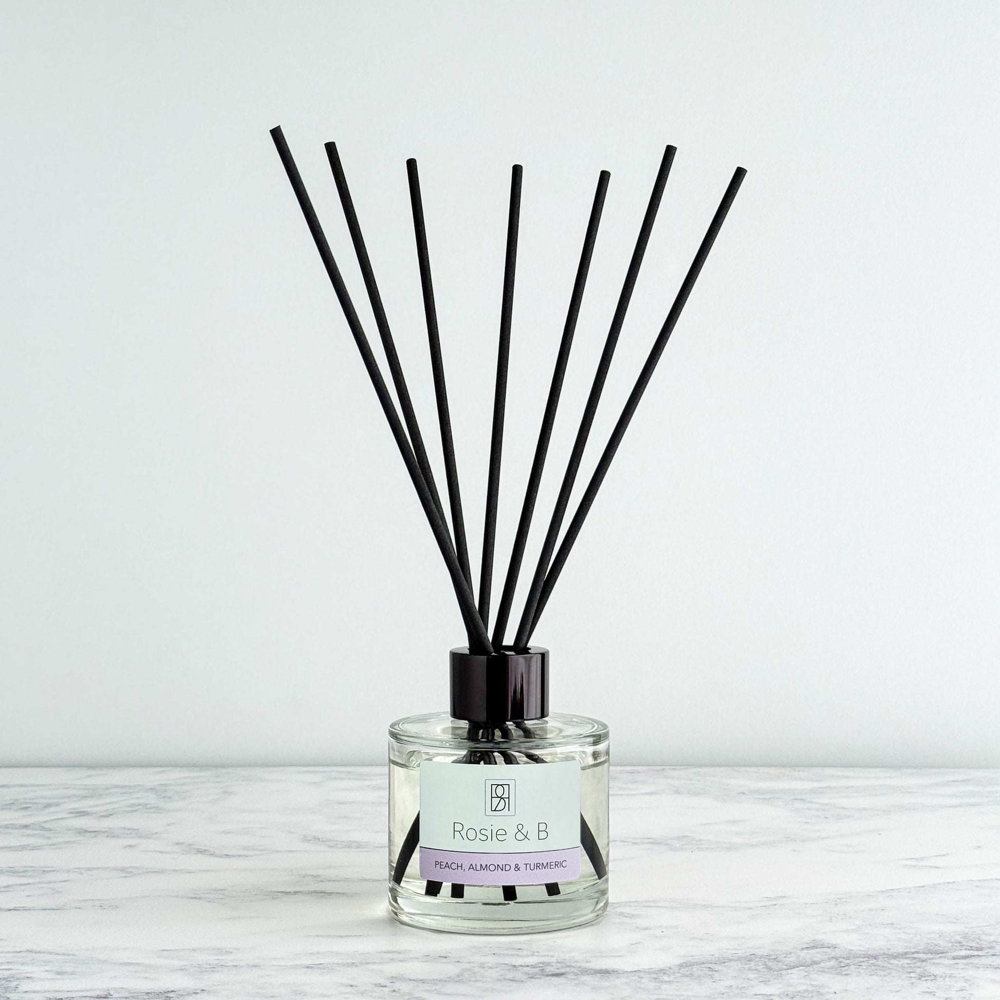 Peach, Almond & Turmeric reed diffuser bottle and reeds