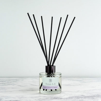 Peach, Almond & Turmeric reed diffuser bottle and reeds