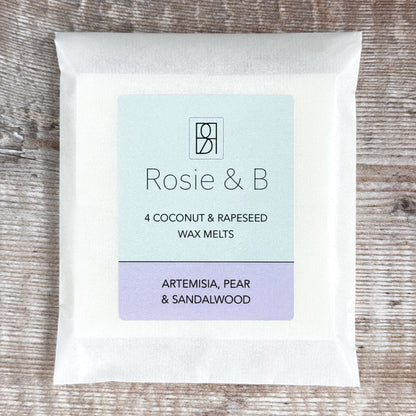 A packet of 4 Artemisia, Pear & Sandalwood wax melts on a wooden background
